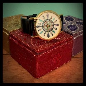 black band watch with feather design in center